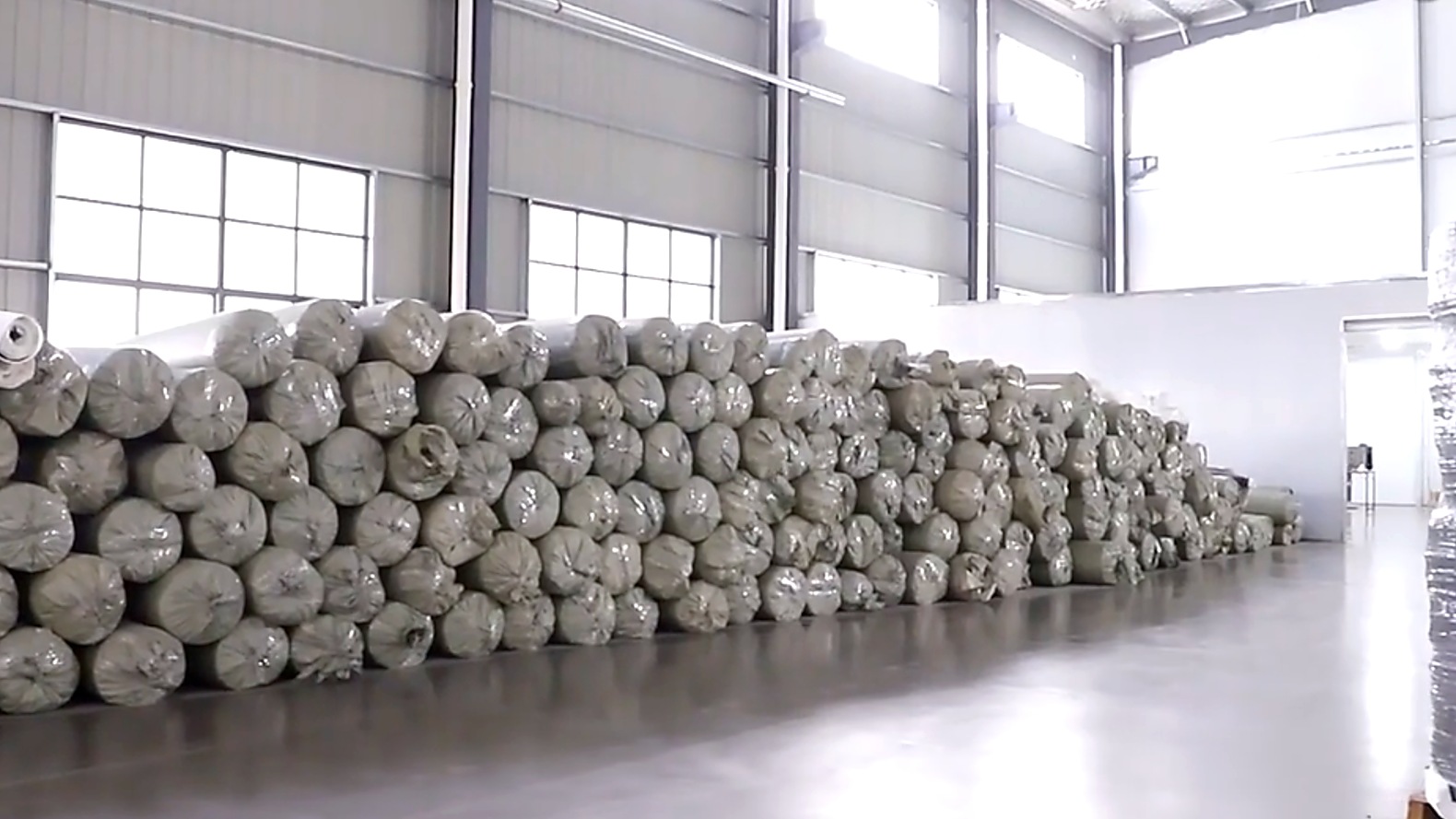 Raw material rolls stored in a production facility