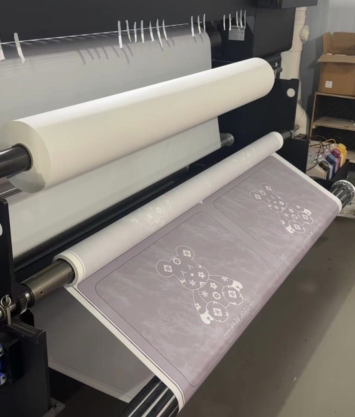 Close-up of a printing machine processing customized soft mat designs